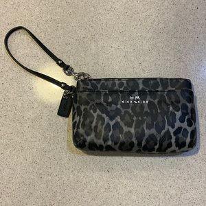 Coach black and gray cheetah print wristlet.
